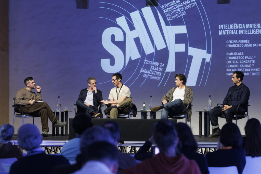 Diverse architects and urban designers engage in panel discussion during the UrbanNext architecture event, focusing on future adaptive architecture and innovative design strategies.